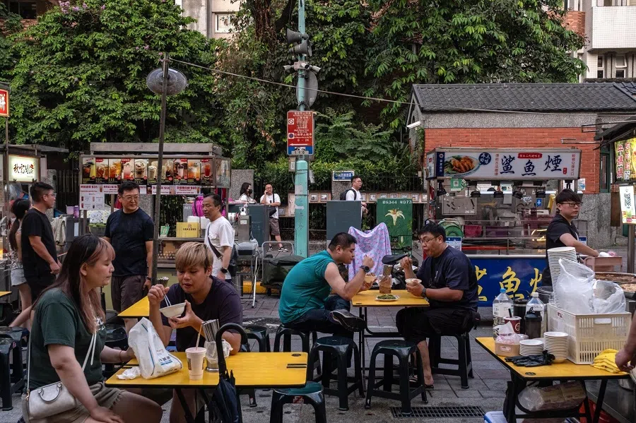 Customers dine at a night market in Taipei, Taiwan, on 8 July 2024. (Lam Yik Fei/Bloomberg)