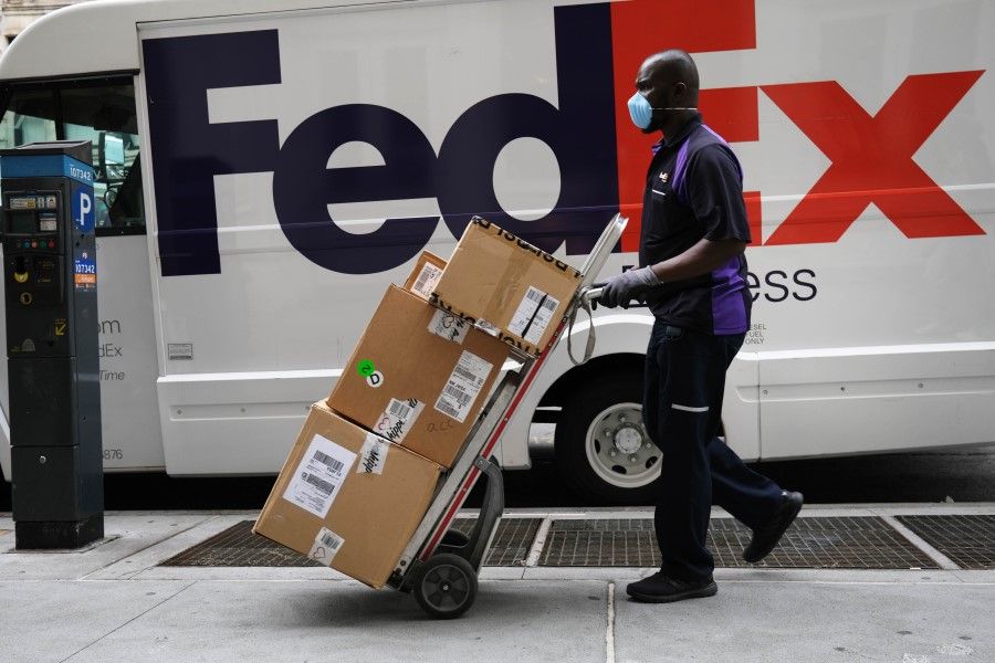 A FedEx driver makes deliveries in Manhattan on 17 September 2020 in New York City. (Spencer Platt/AFP)