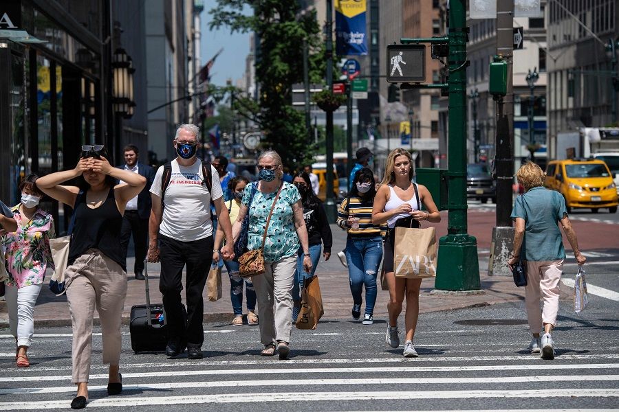 People walk down 5th Avenue on 7 June 2021 in New York City, US. (Angela Weiss/AFP)