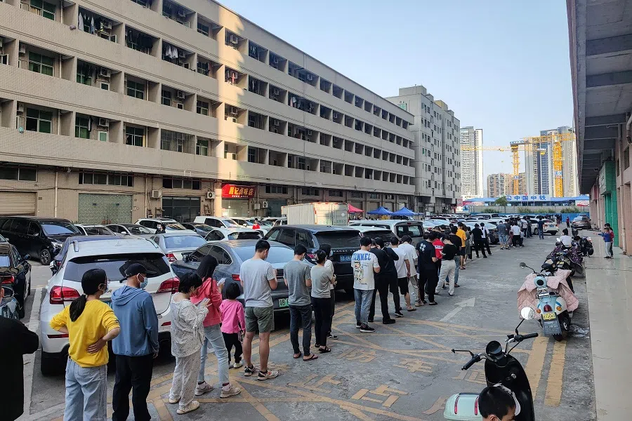 This photo taken on 13 March 2022 shows residents queueing to undergo nucleic acid tests for Covid-19 in Shenzhen, Guangdong province, China. (AFP)