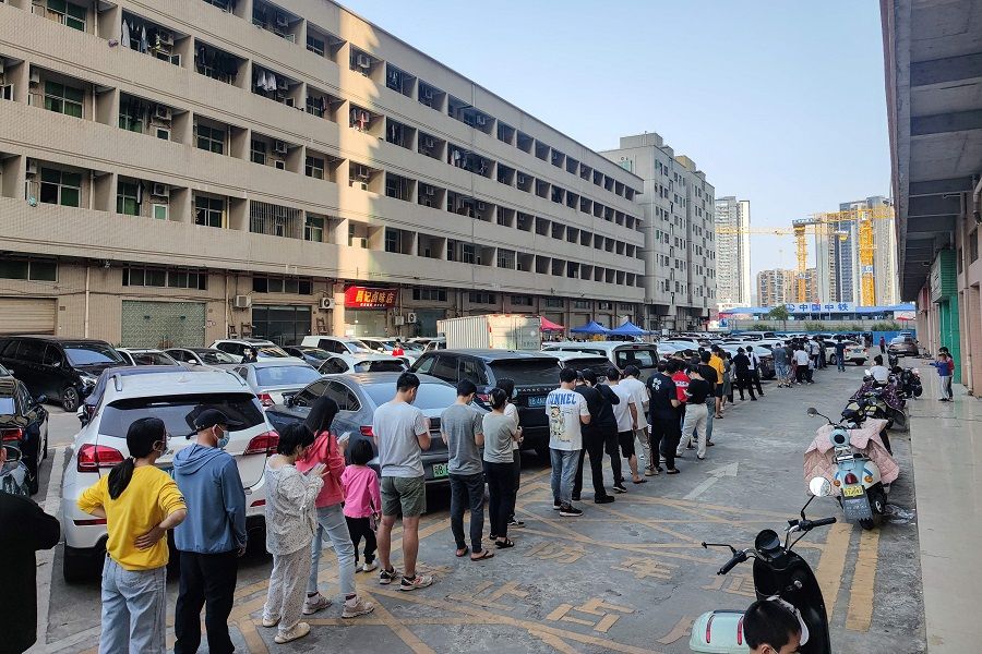 This photo taken on 13 March 2022 shows residents queueing to undergo nucleic acid tests for Covid-19 in Shenzhen, Guangdong province, China. (AFP)