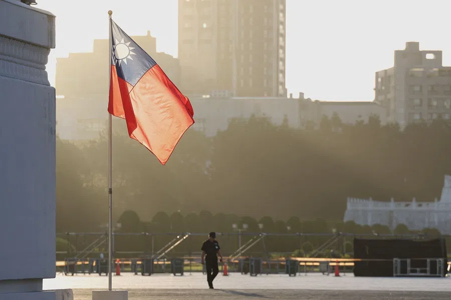 A man walks past a hoisted Taiwanese flag at the Chiang Kai-shek Memorial Hall in Taipei on 15 October 2024. (I-Hwa Cheng/AFP)