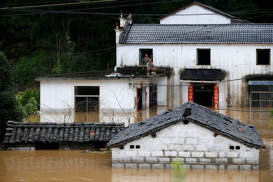People look on from a house at a flooded village following heavy rainfall in Huangshan, Anhui province, China, on 6 July 2020. (CNS photo via Reuters)