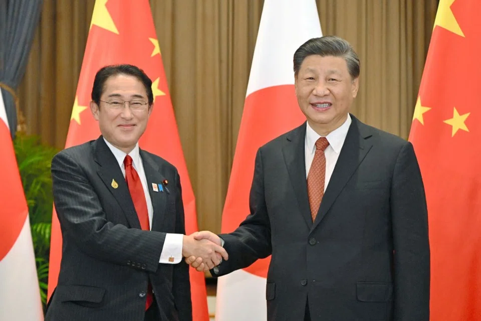 Japan's Prime Minister Fumio Kishida (L) shakes hands with China's President Xi Jinping during their meeting in Bangkok on November 17, 2022, on the sidelines of the Asia-Pacific Economic Cooperation (APEC) Summit. (Jiji Press/AFP)