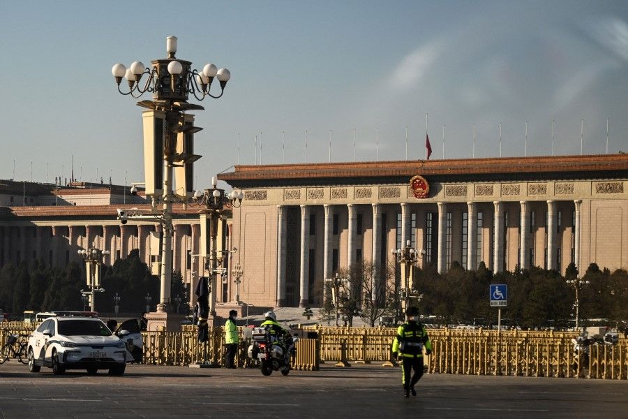 This picture shows police in front of the Great Hall of the People in Beijing on 6 December 2022. (Noel Celis/AFP)