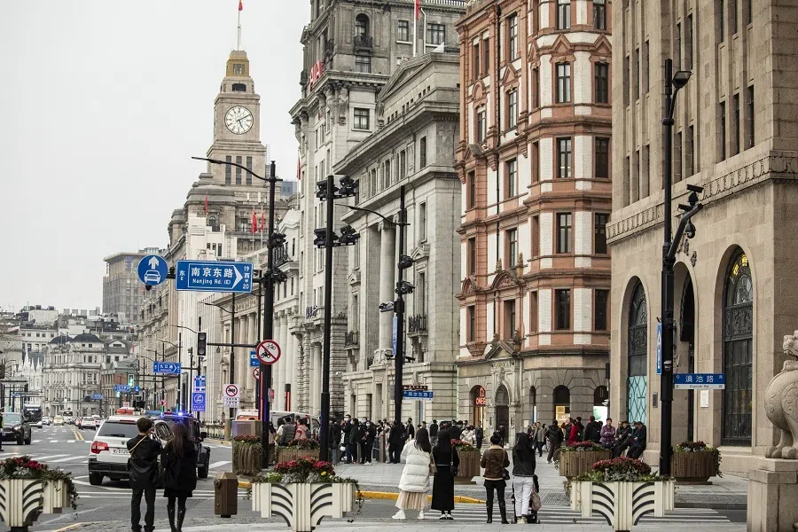 Pedestrians along the Bund in Shanghai, China, on 28 February 2023. (Qilai Shen/Bloomberg)