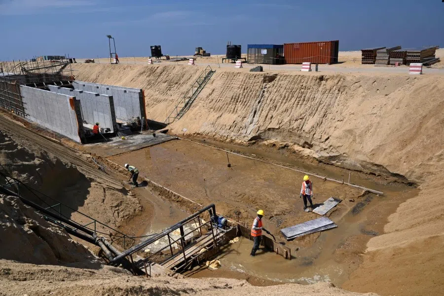 Workers at a construction site on reclaimed land, part of a Chinese-funded project for Port City, in Colombo. (Ishara S. Kodikara/AFP)