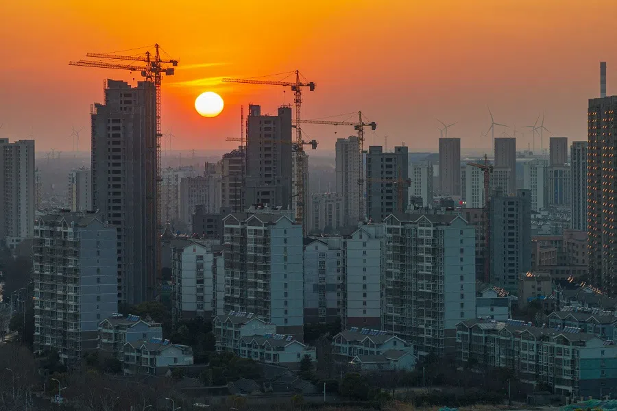 A residential housing complex is seen under construction during sunset in Huaian, in eastern China’s Jiangsu province on 18 March 2025. (AFP)