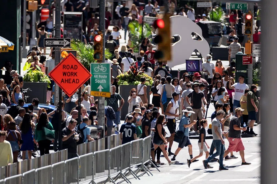 People make their way in a crowded street at Times Square after the Centers for Disease Control and Prevention dropped some of its restrictive Covid-19 preventative measures, including social distancing, in New York, US, 12 August 2022. (Eduardo Munoz/Reuters)
