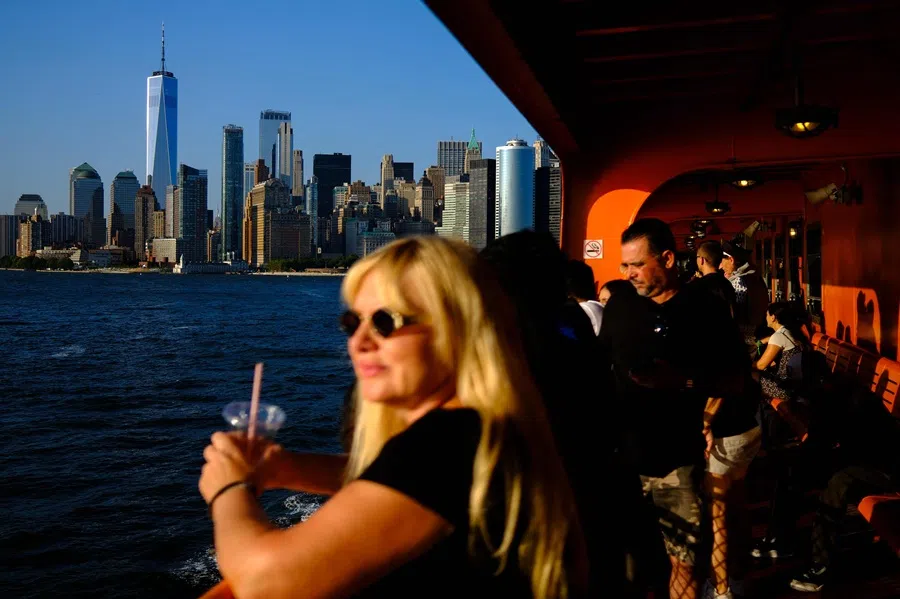 Passengers on the Staten Island Ferry from Manhattan to Staten Island, with One World Trade Center and the downtown Manhattan skyline in the distance in New York City, on 23 July 2024. (Charly Triballeau/AFP)
