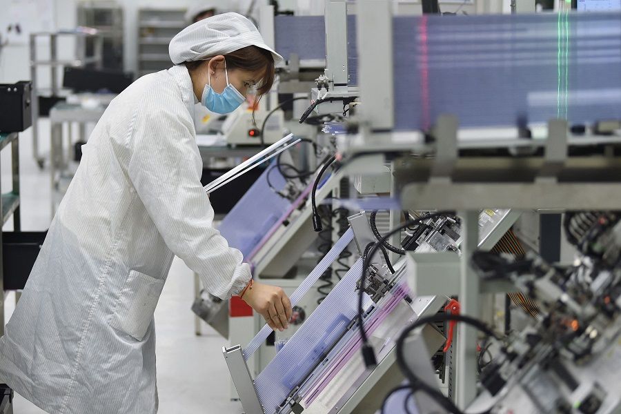 This photo taken on 28 February 2023 shows a worker producing semiconductor chips at a workshop in Suqian, Jiangsu province, China. (AFP)