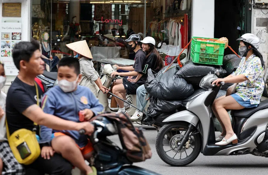 People ride their motorbike in Hanoi, Vietnam, on 25 May 2025. (Ludovic Marin/AFP)