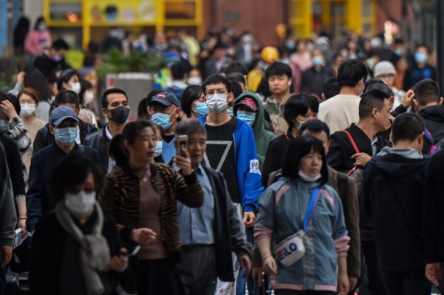 People walk along a pedestrian street in Shanghai on 28 October 2020. (Hector Retamal/AFP)