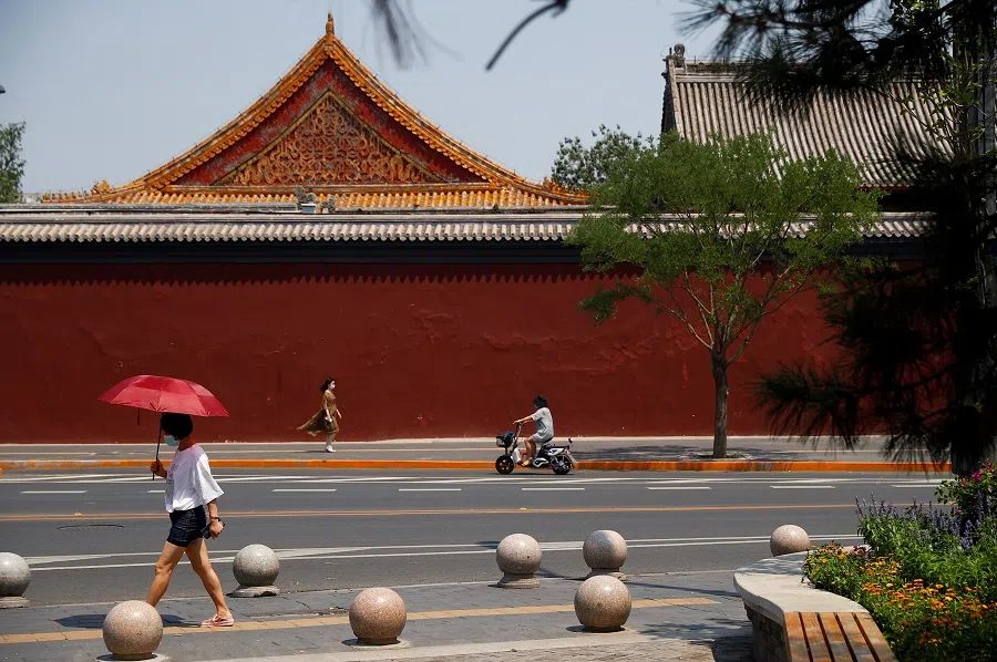 People walk past Lama Temple in Beijing, China, on 19 June 2020. (Thomas Peter/Reuters)