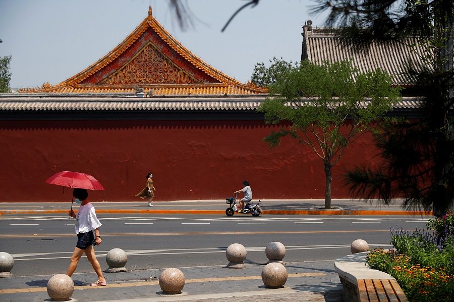 People walk past Lama Temple in Beijing, China, on 19 June 2020. (Thomas Peter/Reuters)