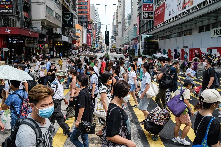 Pedestrians walk across a main road in Hong Kong on 20 July 2020. (Anthony Wallace/AFP)
