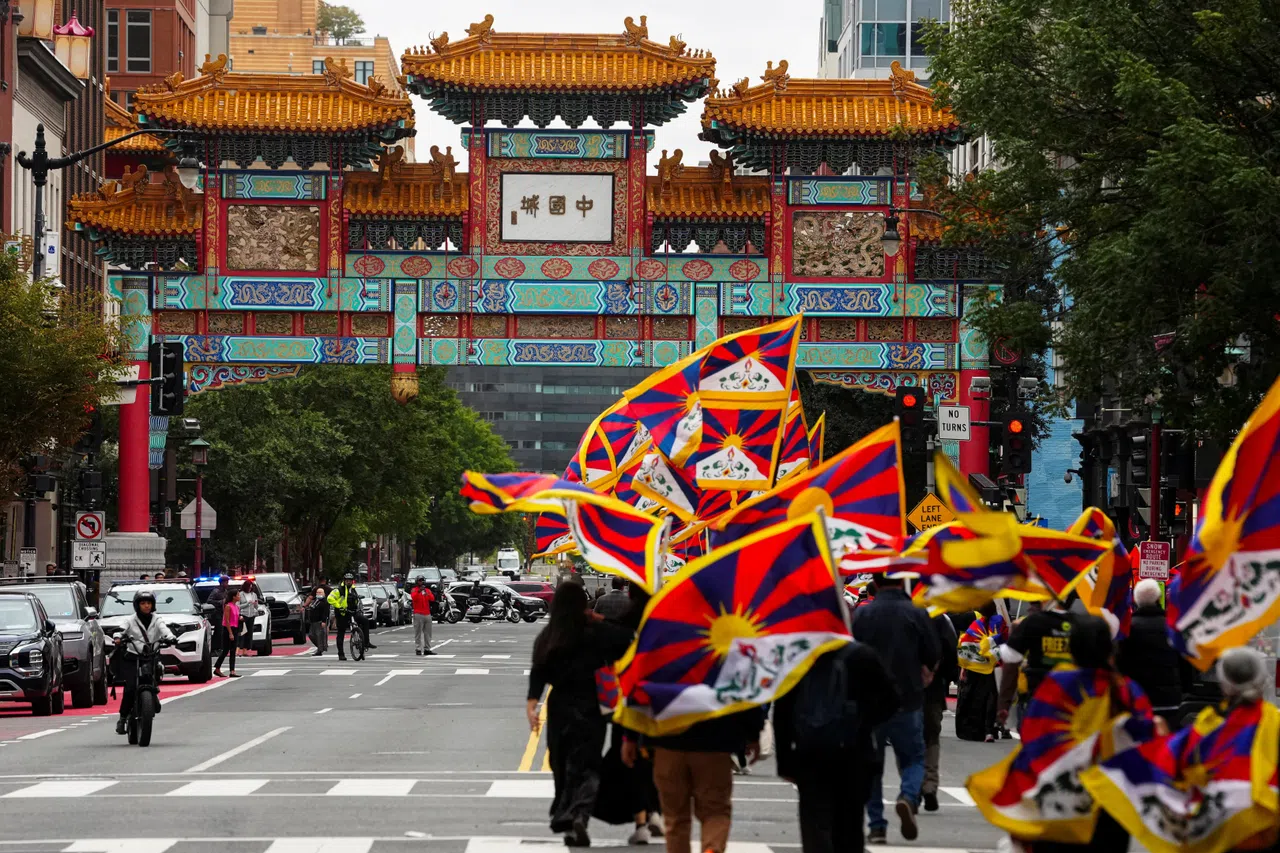 Demonstrators walk past Chinatown's Friendship Archway, as they take part in a procession during a "Free Tibet" protest against Chinese President Xi Jinping's state visit to the US, in Washington, DC, US, 24 September 2026.