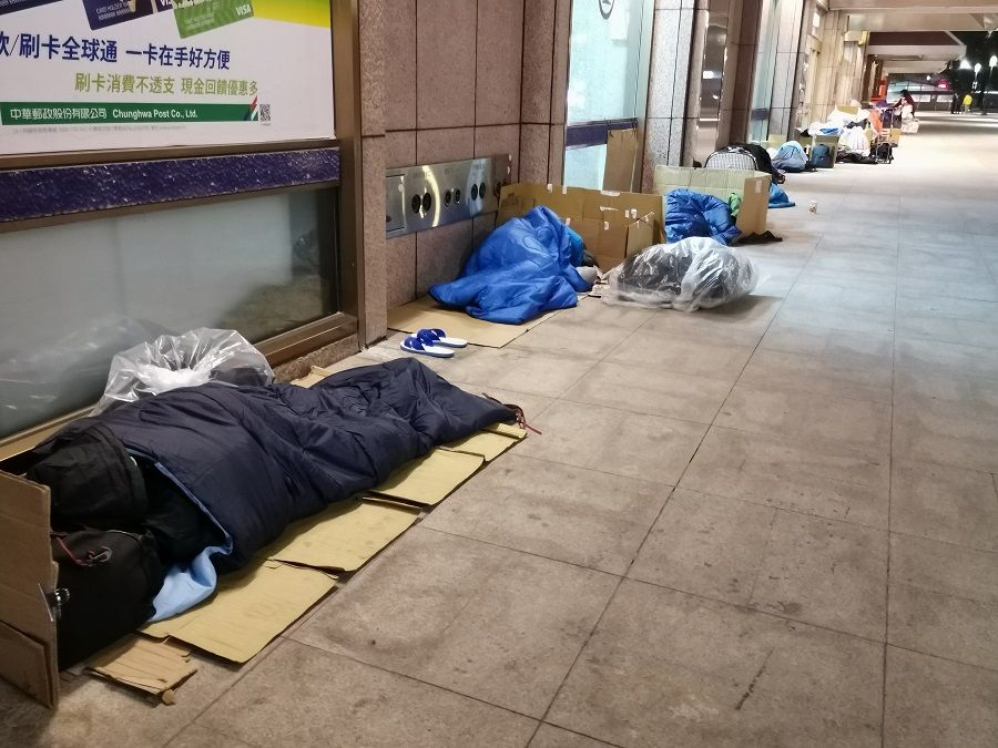 Homeless people sleeping on the streets.