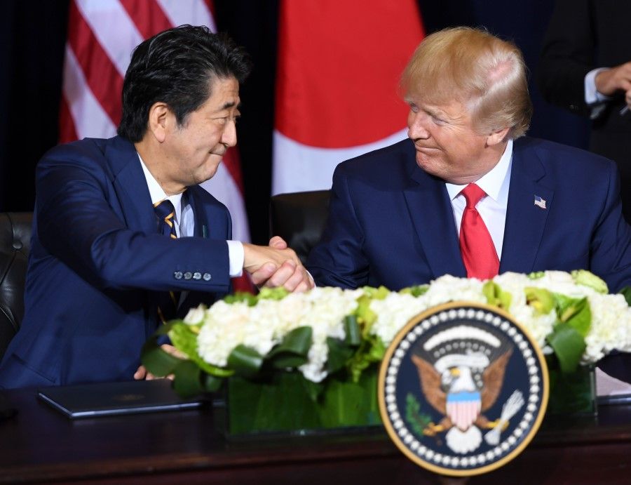 In this file photo taken on 25 September 2020, US President Donald Trump and Japanese Prime Minister Shinzo Abe shake hands after signing a trade agreement in New York, on the sidelines of the United Nations General Assembly. US President Donald Trump on 30 August 2020 praised outgoing Prime Minister Shinzo Abe as Japan's best head of government ever. (Saul Loeb/AFP)