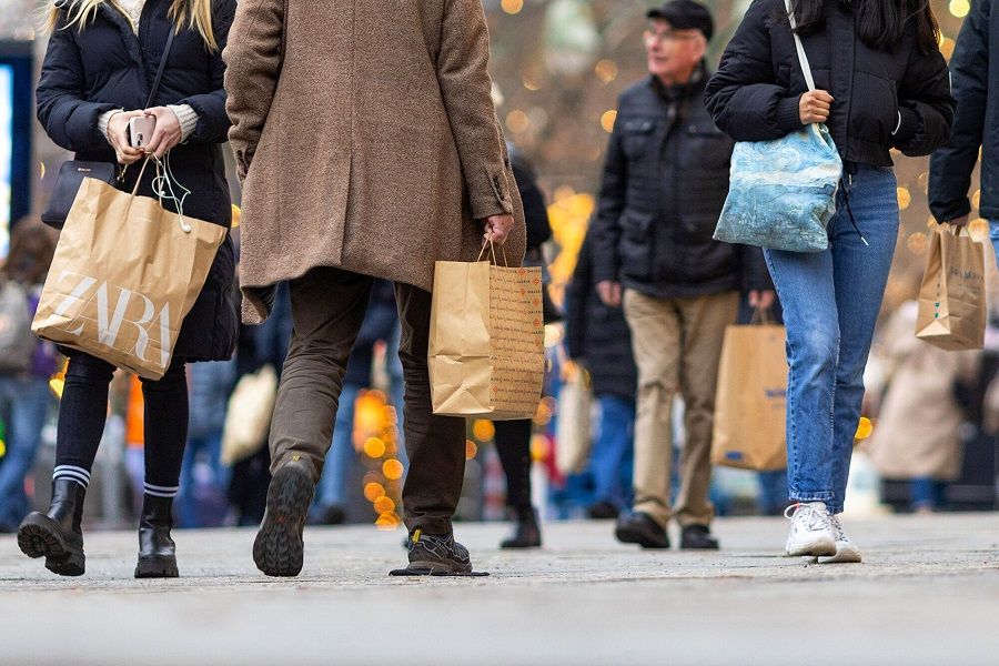 Shoppers walk along a street in Berlin, Germany, on 14 December 2023. (Krisztian Bocsi/Bloomberg)
