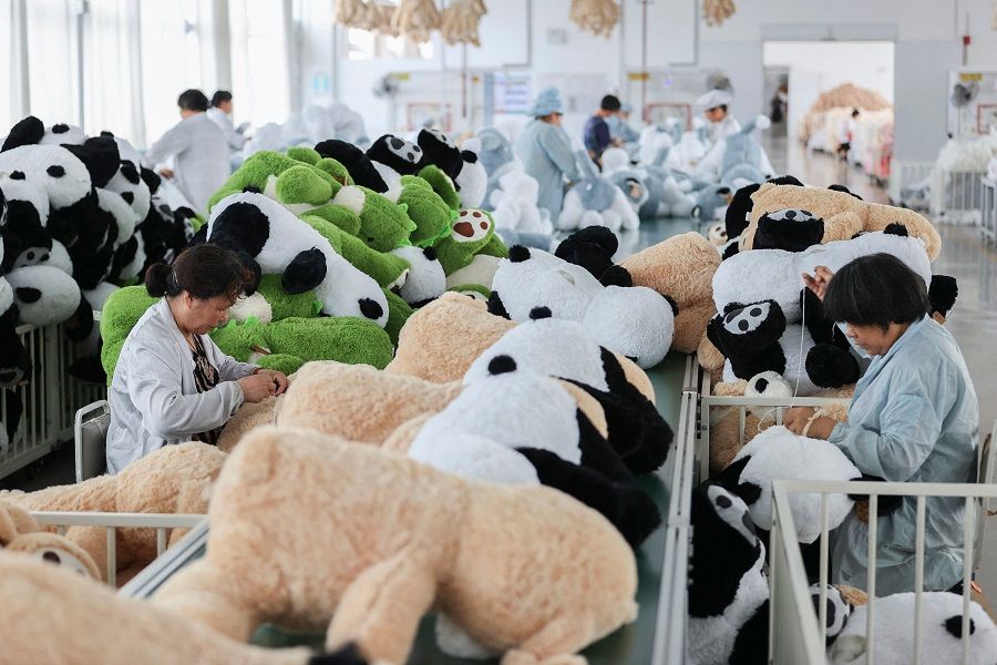 Workers produce stuffed toys that will be exported at a factory in Lianyungang, Jiangsu province, China, on 7 July 2022. (AFP)
