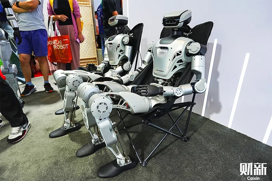 Humanoid robots sit at the World Robot Conference in Beijing on 8 August 2025. (Liu Peilin/Caixin)