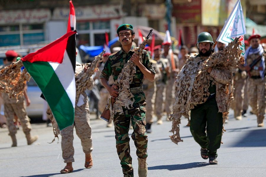 Forces loyal to Yemen's Houthi rebels hold up Palestinian flags as they march in a show of solidarity with the Palestinians on 15 October 2023, in Sanaa. (Mohammed Huwais/AFP)