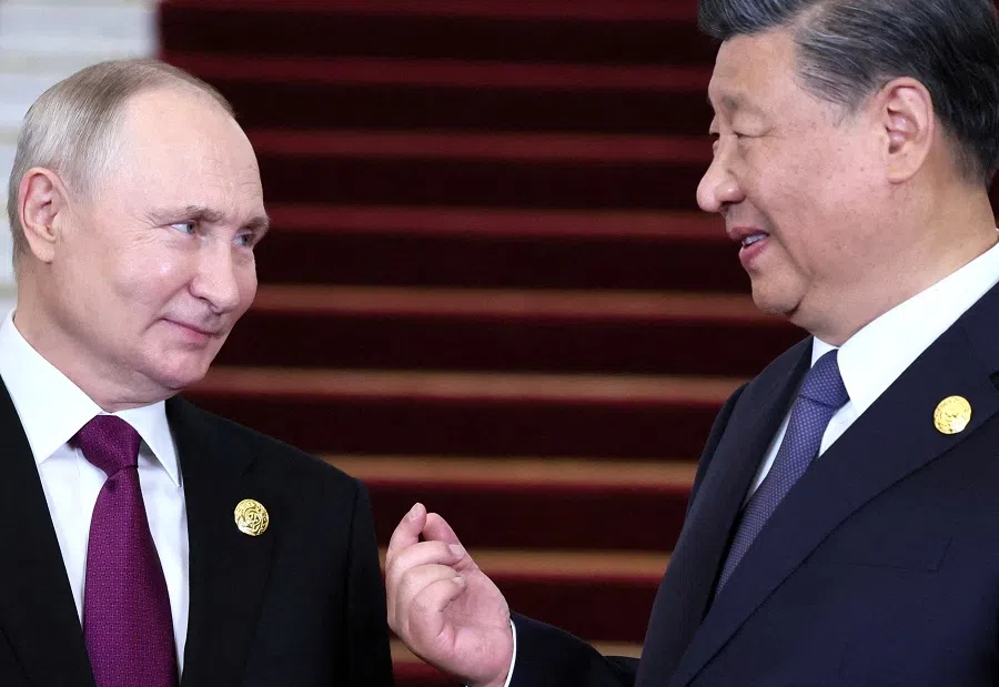 Russian President Vladimir Putin speaks with Chinese President Xi Jinping during a welcoming ceremony at the Belt and Road Forum in Beijing, China, on 17 October 2023.  (Sputnik/Sergei Savostyanov/Pool via Reuters)