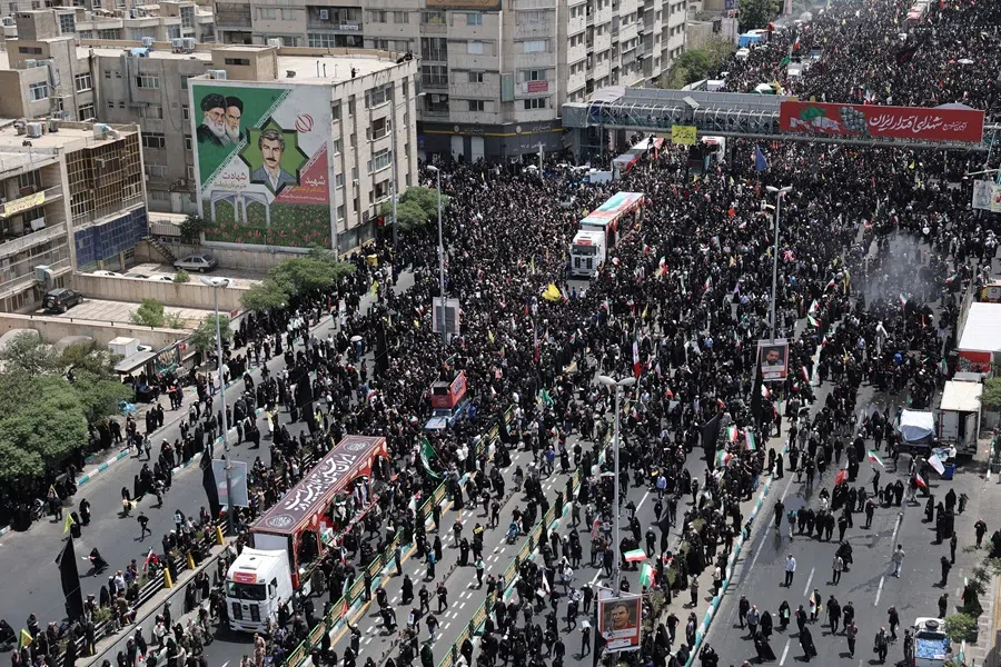 People attend the funeral procession of Iranian military commanders, nuclear scientists and others killed in Israeli strikes, in Tehran, Iran, on 28 June 2025. (Majid Asgaripour/West Asia News Agency via Reuters)