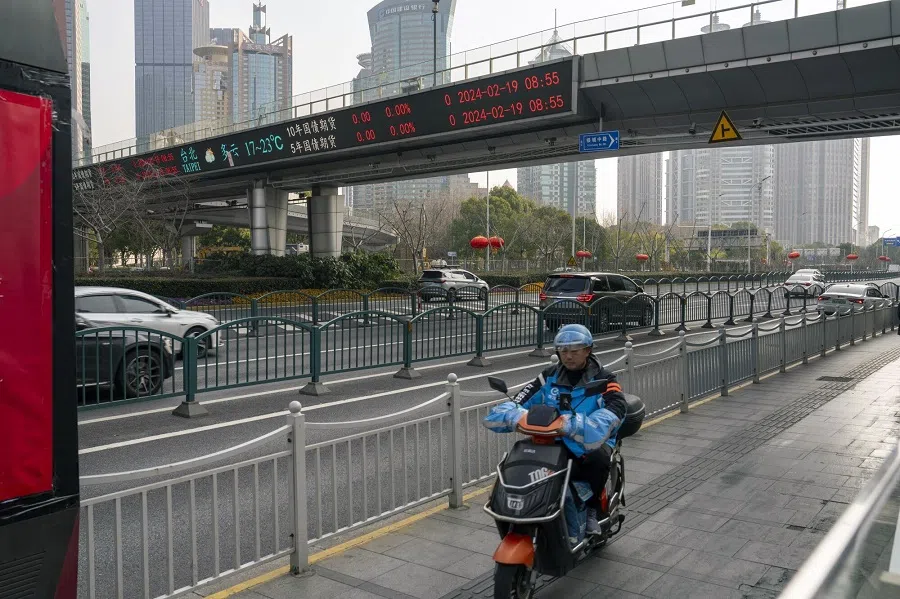 An electronic ticker displays stock figures in Pudong's Lujiazui financial district in Shanghai, China, on 19 February 2024. (Raul Ariano/Bloomberg)