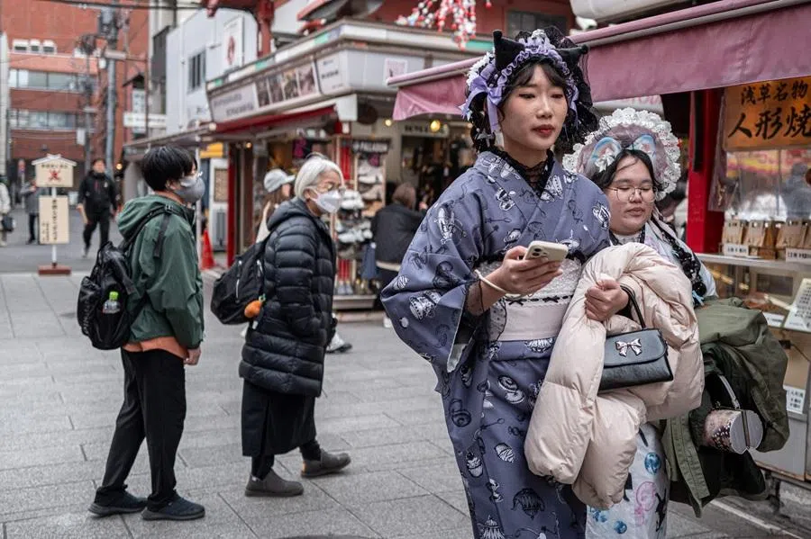 People visit a shopping street in Asakusa district near Sensoji Temple, a popular tourist location in Tokyo, on 20 January 2026. (Philip Fong/AFP)