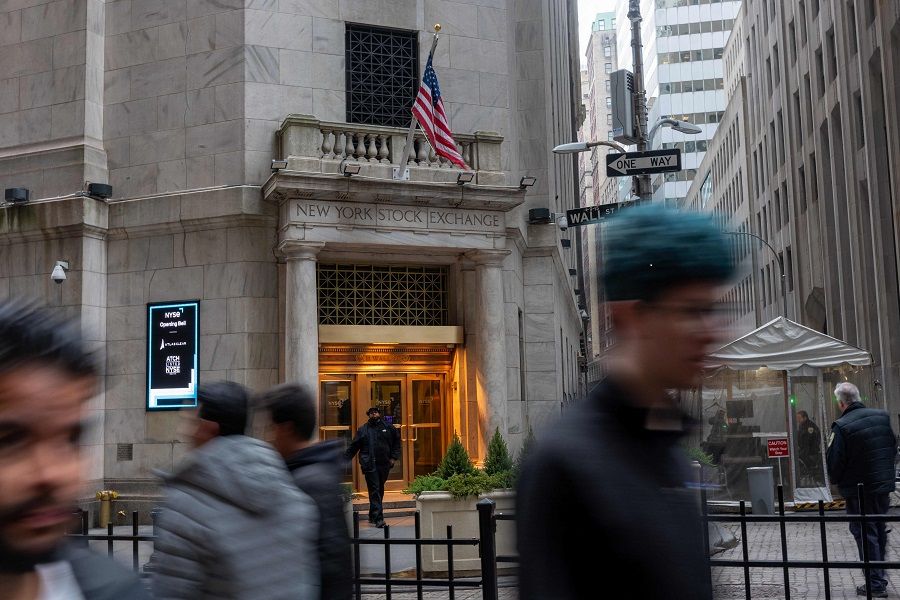 People walk by the New York Stock Exchange (NYSE) on 6 March 2024 in New York City. (Spencer Platt/AFP)