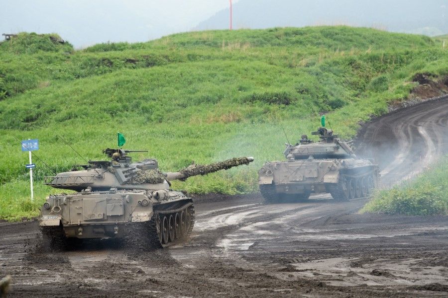 Japan's Ground Self-Defense Forces (JGSDF) Type-74 tanks move during a live fire exercise at the JGSDF training grounds in the East Fuji Manuever Area in Gotemba on 22 May 2021. (Akio Kon/AFP)