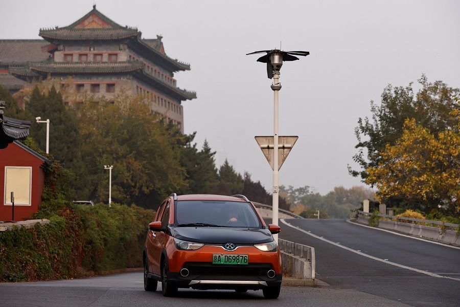 An electric vehicle (EV) by BAIC Group moves on a street in Beijing, China, on 31 October 2023. (Tingshu Wang/Reuters)