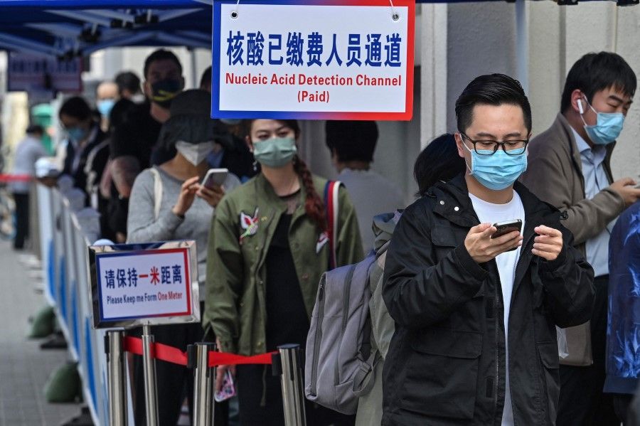 People queue up to be tested as a measure against Covid-19 at the Shanghai Jin'an Central Hospital, in Shanghai on 14 March 2022. (Hector Retamal/AFP)