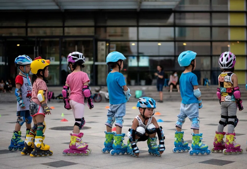 Children learn skating in Beijing on 11 August 2020. (Noel Celis/AFP)