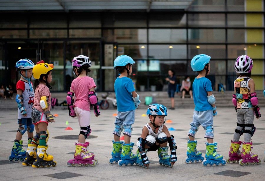 Children learn skating in Beijing on 11 August 2020. (Noel Celis/AFP)