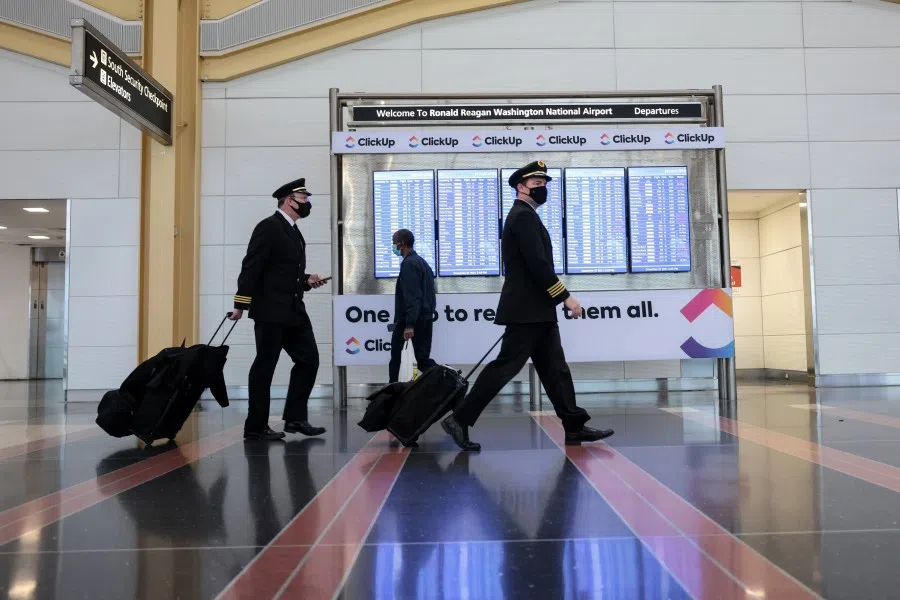 Airline pilots walk through the Ronald Reagan Washington National Airport on 27 December 2021 in Arlington, Virginia. (Anna Moneymaker/Getty Images/AFP)