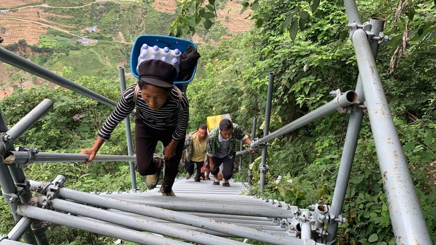 Villagers climbing a series of steel stairs and ladders to reach their homes in the village of Atulie'er in Liangshan Yi Autonomous Prefecture in Sichuan province, China. (SPH Media)