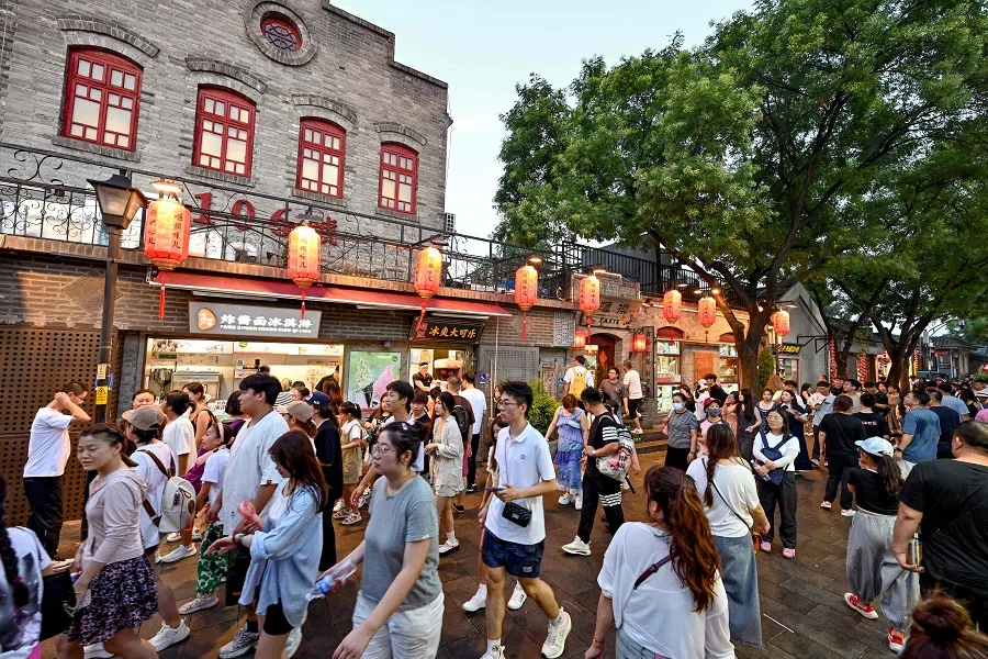 People visit Nanluoguxiang in Beijing, China, on 20 July 2024. (Adek Berry/AFP)