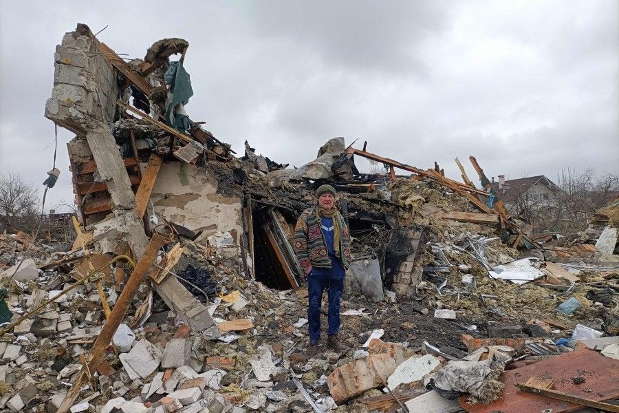 A Ukrainian man stands in the rubble in Zhytomyr on 2 March 2022, following a Russian bombing the day before. (Emmanuel Duparcq/AFP)