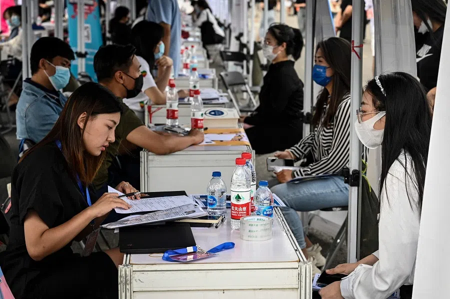 This photo taken on 26 August 2022 shows young people attending a job fair in Beijing, China. (Jade Gao/AFP)
