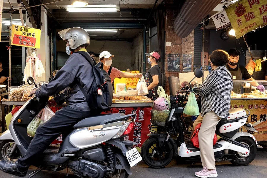 People on scooters shop at Hulin Market, in Taipei, Taiwan on 31 October 2023. (I-Hwa Cheng/AFP)