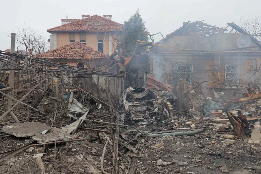 This photograph taken on 15 March 2024 shows a destroyed car in front of damaged houses following a missile attack in Odesa, amid the Russian invasion of Ukraine. (Oleksandr Gimanov/AFP)