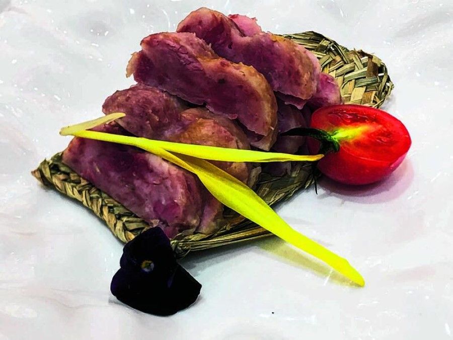 Pork wrapped in cattail displayed on a plate. (Courtesy of Shen Jialu)