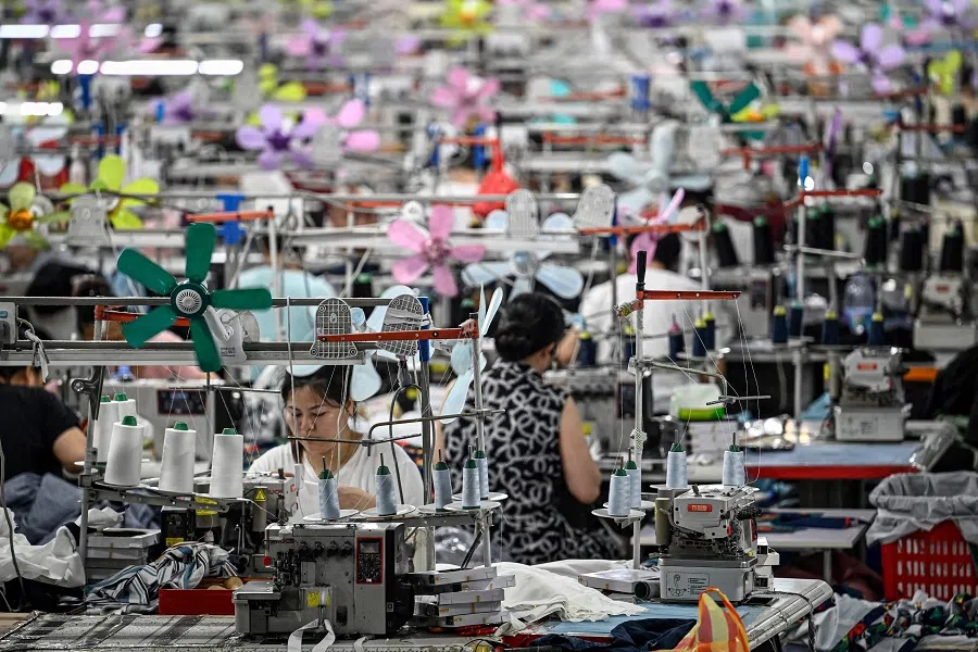 This photo taken on 11 June 2024 shows workers producing garments at a textile factory that supplies clothes to fast fashion e-commerce company Shein in Guangzhou in southern China’s Guangdong province. (Jade Gao/AFP)