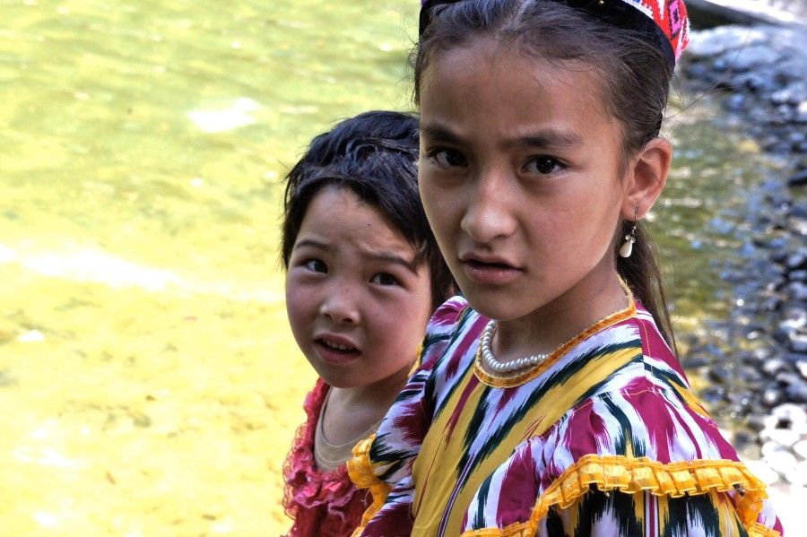 In this photo received by AFP on 24 April 2021, two Uighur girls are seen in Peoples Park in Urumqi in 2011. (Gary and Andrea Dyck/Family Handout/AFP)