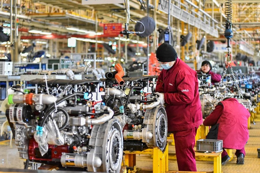 Employees work on a vehicle assembly line at a JAC Automotive factory in Qingzhou, Shandong province, China, on 31 January 2023. (AFP)