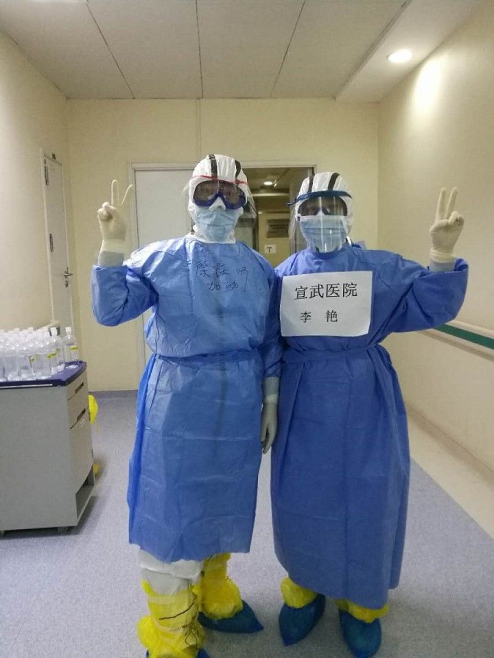 Dr Li Yan and her colleague in their personal protective equipment.