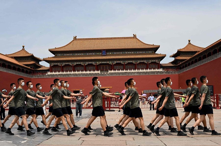 Chinese People's Liberation Army (PLA) soldiers march past the entrance of the Forbidden City in Beijing, China on 12 June 2021. (Noel Celis/AFP)